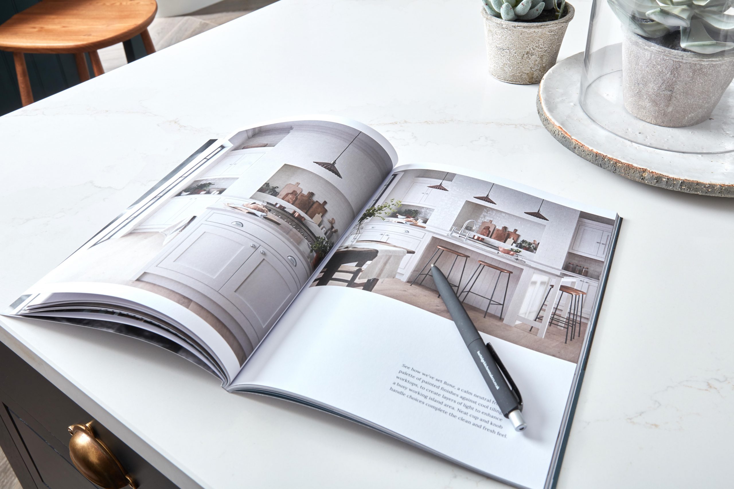Kitchen Makers Brochure open on table with pen